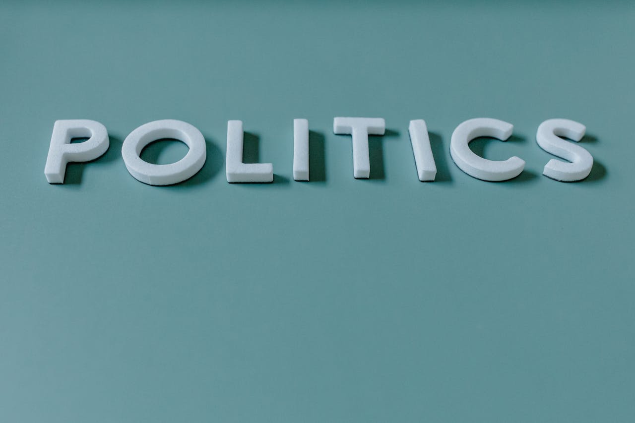 The Art of Drawing Readers In: Your attractive post title goes here Close-up image of the word 'Politics' against a teal green background, highlighting political themes.