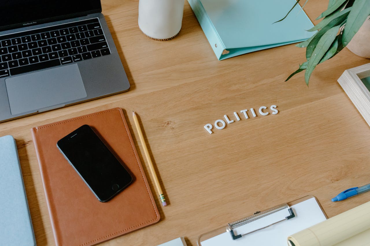 Crafting Captivating Headlines: Your awesome post title goes here Neat office desk setup with laptop, smartphone, and political theme.